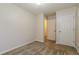 A carpeted bedroom with two white doors and neutral paint at 8409 Carlington Ln, Jonesboro, GA 30236