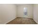 Neutral room filled with plush carpet and a bright window at 8409 Carlington Ln, Jonesboro, GA 30236
