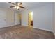 Spacious bedroom with a ceiling fan, neutral carpeting, and two closet doors at 8409 Carlington Ln, Jonesboro, GA 30236