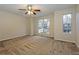 Spacious bedroom with neutral paint, plush carpeting and an updated ceiling fan at 8409 Carlington Ln, Jonesboro, GA 30236