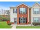 Charming two-story townhome featuring brick and vinyl siding, black shutters and a well-maintained lawn at 8409 Carlington Ln, Jonesboro, GA 30236