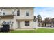 The back of an apartment building featuring vinyl siding and a well-maintained lawn at 8409 Carlington Ln, Jonesboro, GA 30236