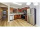Modern kitchen with stainless steel appliances, mosaic backsplash, and durable wood-look flooring at 8409 Carlington Ln, Jonesboro, GA 30236