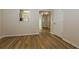 Bright, open living room with durable wood-look floors leading to the hallway at 8409 Carlington Ln, Jonesboro, GA 30236