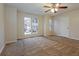 Spacious main bedroom with a ceiling fan, neutral carpeting, and large windows at 8409 Carlington Ln, Jonesboro, GA 30236
