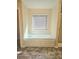 Bathroom featuring a bathtub with tile surround and a window with blinds above at 1172 Preserve Park Dr, Loganville, GA 30052
