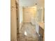Bathroom featuring double sinks, a soaking tub, and tile flooring at 1172 Preserve Park Dr, Loganville, GA 30052