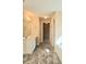 Bright bathroom featuring double sinks, a marble floor, and access to a walk-in closet at 1172 Preserve Park Dr, Loganville, GA 30052