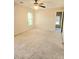 Spacious bedroom with neutral carpet, ceiling fan, and a window for natural light at 1172 Preserve Park Dr, Loganville, GA 30052