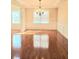 Elegant dining room featuring decorative trim, hardwood floors, and modern chandelier at 1172 Preserve Park Dr, Loganville, GA 30052