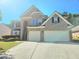 Charming two-story home featuring a two-car garage and manicured landscaping at 1172 Preserve Park Dr, Loganville, GA 30052