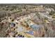 This aerial shot highlights the upscale community, with mature trees, a pool, and well-kept tennis courts at 1540 Turtle Pond Dr, Hoschton, GA 30548