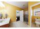 Bright bathroom showcasing tile flooring, single sink vanity and separate toilet room at 1540 Turtle Pond Dr, Hoschton, GA 30548