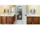 Bathroom featuring double sink vanity, tile flooring, and view to hallway at 1540 Turtle Pond Dr, Hoschton, GA 30548