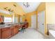 Bathroom with double sink vanity, large mirror, and separate tub and shower at 1540 Turtle Pond Dr, Hoschton, GA 30548