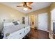 Bedroom featuring hardwood flooring, bed with blanket and view to bathroom at 1540 Turtle Pond Dr, Hoschton, GA 30548
