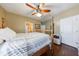 Bedroom with hardwood floors, a striped bed, and warm natural light at 1540 Turtle Pond Dr, Hoschton, GA 30548