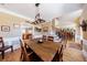 Open dining area with hardwood floors and custom staircase at 1540 Turtle Pond Dr, Hoschton, GA 30548