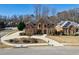 Stately brick home with a lush, landscaped front yard and a circular driveway in a desirable neighborhood at 1540 Turtle Pond Dr, Hoschton, GA 30548