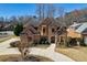 Beautiful two-story brick home with manicured landscaping, a spacious driveway, and a classic roof design at 1540 Turtle Pond Dr, Hoschton, GA 30548