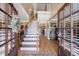 Inviting home foyer with hardwood floors, a grand staircase, elegant lighting, and decorative details at 1540 Turtle Pond Dr, Hoschton, GA 30548