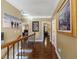 Hallway boasting hardwood floors, and natural light cascading through doorway to other rooms at 1540 Turtle Pond Dr, Hoschton, GA 30548