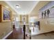 Bright hallway with hardwood floors, beautiful chandelier, and stairway access to the main floor at 1540 Turtle Pond Dr, Hoschton, GA 30548