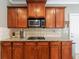 Well-equipped kitchen features granite countertops and custom cabinets at 1540 Turtle Pond Dr, Hoschton, GA 30548