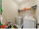 Laundry room features washer, dryer and wire shelving at 1540 Turtle Pond Dr, Hoschton, GA 30548