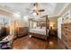 Charming main bedroom with natural light, hardwood floors, wood furniture, and a fan at 1540 Turtle Pond Dr, Hoschton, GA 30548