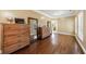 Bright main bedroom with hardwood floors, a dresser, and a mirror at 1540 Turtle Pond Dr, Hoschton, GA 30548