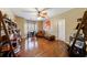 Spacious office features a ceiling fan, hardwood floors, and desk at 1540 Turtle Pond Dr, Hoschton, GA 30548