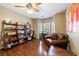Office area featuring hardwood flooring, a desk and ceiling fan at 1540 Turtle Pond Dr, Hoschton, GA 30548