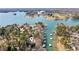 Aerial view showcasing lakefront property with a variety of boat docks and verdant foliage at 7410 Fields Dr, Cumming, GA 30041