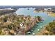 Aerial view of a waterfront property, showcasing the house and boat dock on a beautiful lake setting at 7410 Fields Dr, Cumming, GA 30041