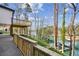 Backyard view featuring a multi-level deck overlooking the water with boat docks at 7410 Fields Dr, Cumming, GA 30041
