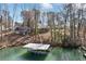 Elevated view of a waterfront home, showcasing a private dock and lush backyard leading to the water at 7410 Fields Dr, Cumming, GA 30041