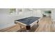 Finished basement with a pool table, sitting area, and wood floors at 7410 Fields Dr, Cumming, GA 30041
