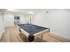 Finished basement featuring a billiard table, neutral paint, and wood floors, ideal for entertaining or recreation at 7410 Fields Dr, Cumming, GA 30041