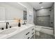 Bright bathroom with double vanity, large mirror, and modern shower featuring stylish tile work at 7410 Fields Dr, Cumming, GA 30041