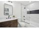 Updated bathroom features a modern vanity, decorative mirror, stylish tile and shower with a black shower head and fixtures at 7410 Fields Dr, Cumming, GA 30041