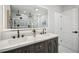 Modern bathroom with a double sink vanity, decorative mirror and large walk-in shower at 7410 Fields Dr, Cumming, GA 30041