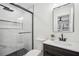 Renovated bathroom features a glass-enclosed shower, modern vanity, stylish tile, and sleek fixtures for a contemporary look at 7410 Fields Dr, Cumming, GA 30041