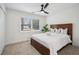 Bright bedroom with carpet features a ceiling fan and window for natural light, and includes a neutral colored bed and furnishings at 7410 Fields Dr, Cumming, GA 30041