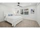 Clean bedroom with carpet, ceiling fan and a window with outside views at 7410 Fields Dr, Cumming, GA 30041