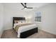 Cozy bedroom with modern dark furnishings, ceiling fan and natural light from window at 7410 Fields Dr, Cumming, GA 30041