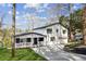Charming home with a welcoming front porch, well-maintained lawn, and stylish exterior paint and modern design at 7410 Fields Dr, Cumming, GA 30041