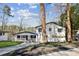 Charming two-story home with white siding, black trim, attached garage and a well-manicured front yard at 7410 Fields Dr, Cumming, GA 30041