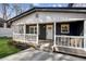 Inviting front porch with cozy seating, a ceiling fan and providing a relaxing outdoor space with stylish accents at 7410 Fields Dr, Cumming, GA 30041