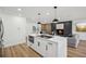 Kitchen island featuring a smooth cooktop with black hardware, stainless steel appliances, and a seamless design at 7410 Fields Dr, Cumming, GA 30041